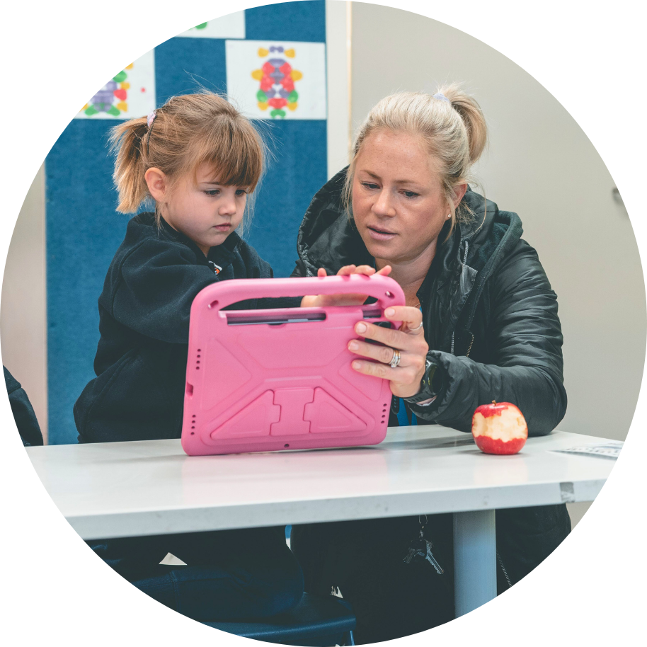Teacher And Student Using The Curriculum