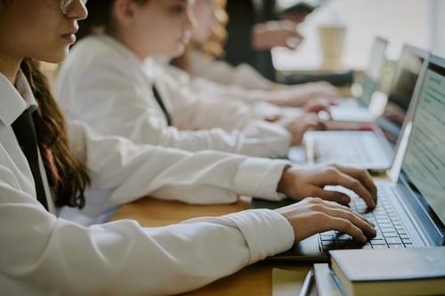 Student typing on laptop