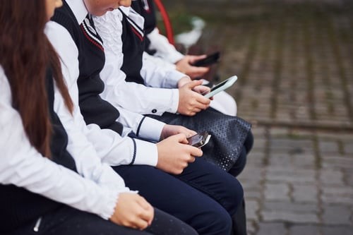 Students In Row On Device